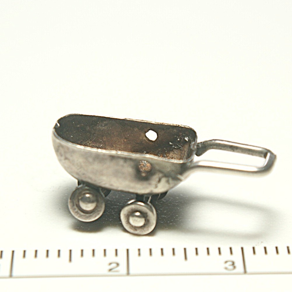 Sterling silver baby carriage 15mm long, 1.10 grams, wheels turn, no hood.